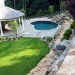Newly installed bluestone pool decking and retaining wall