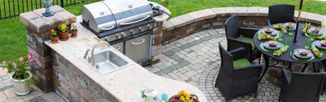 Outdoor kitchen with stone paver patio