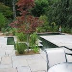 Geometric stone patio with inset pond areas